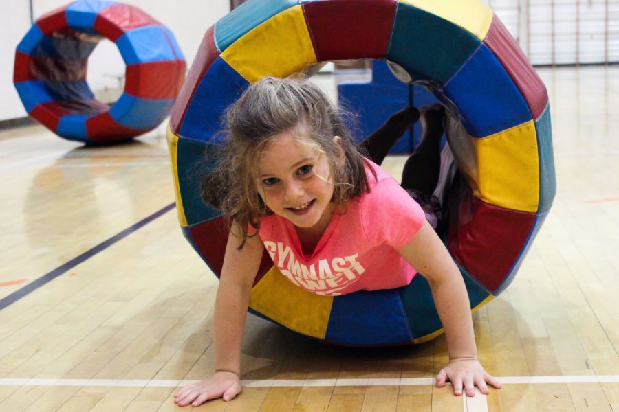 A Fun, Froggie Fitness class has fun in the gymnasium.