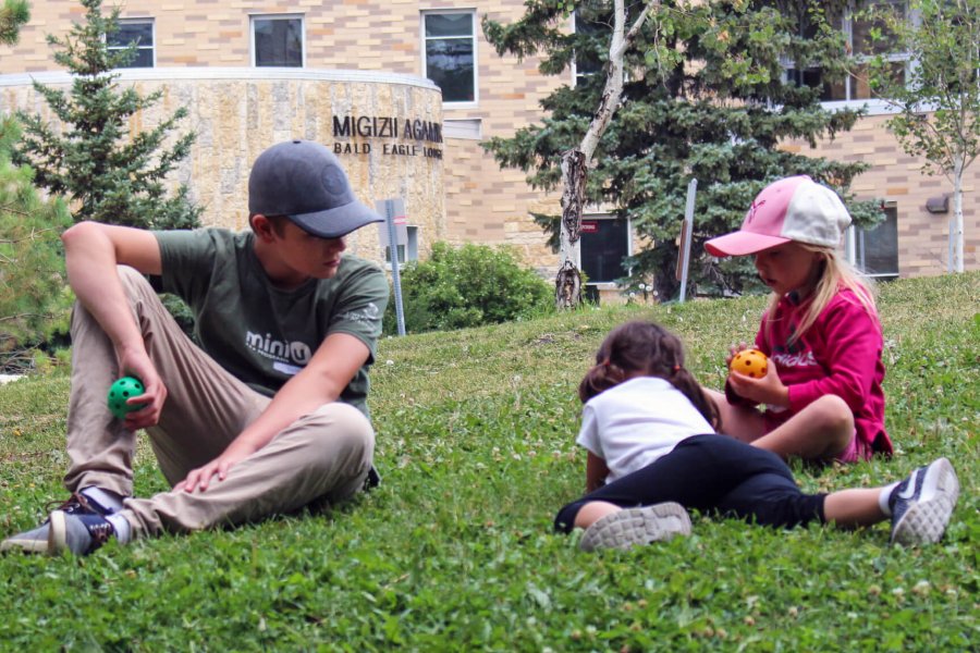 A senior Mini U participant working with other Mini U kids.