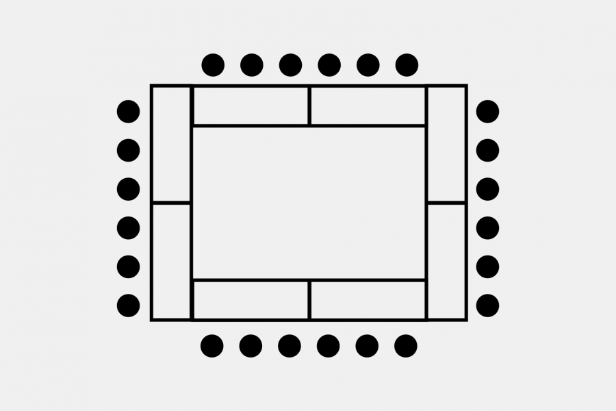 Eight rectangular tables form a hollow square with seating along all four exterior edges.