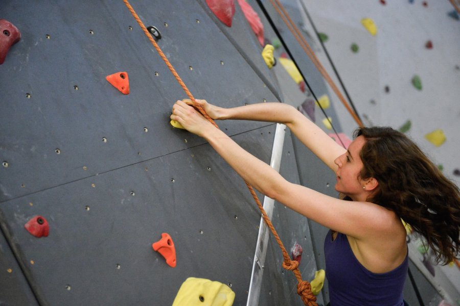 student climbing indoor climbing wall