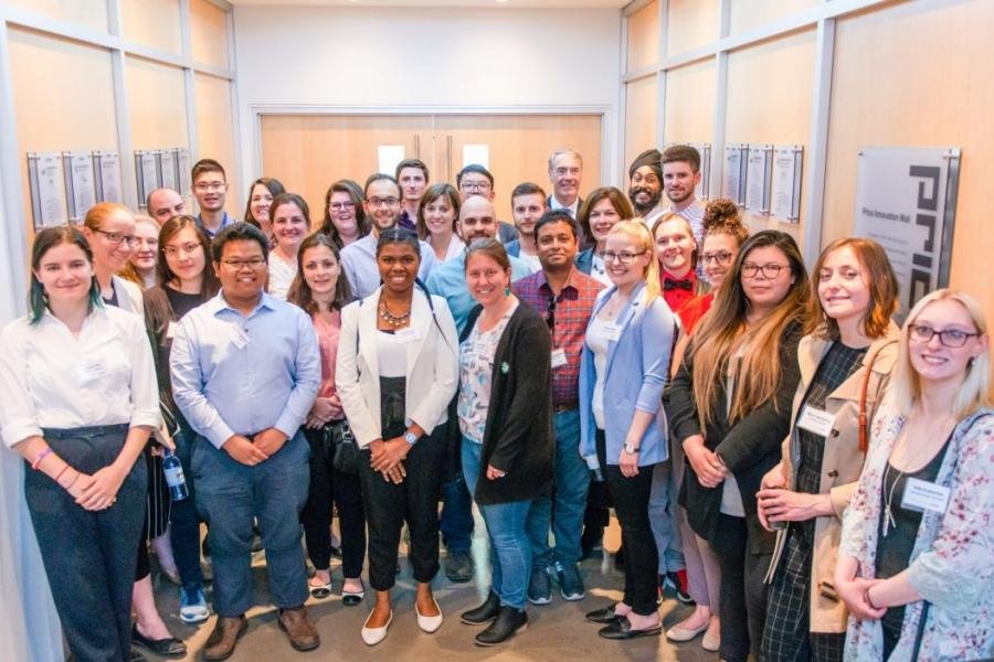 The inaugural cohort of the President's Leadership Program all standing together side by side in several rows. 