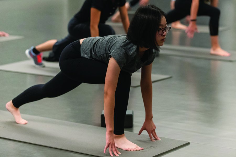 student exercising in group fitness class