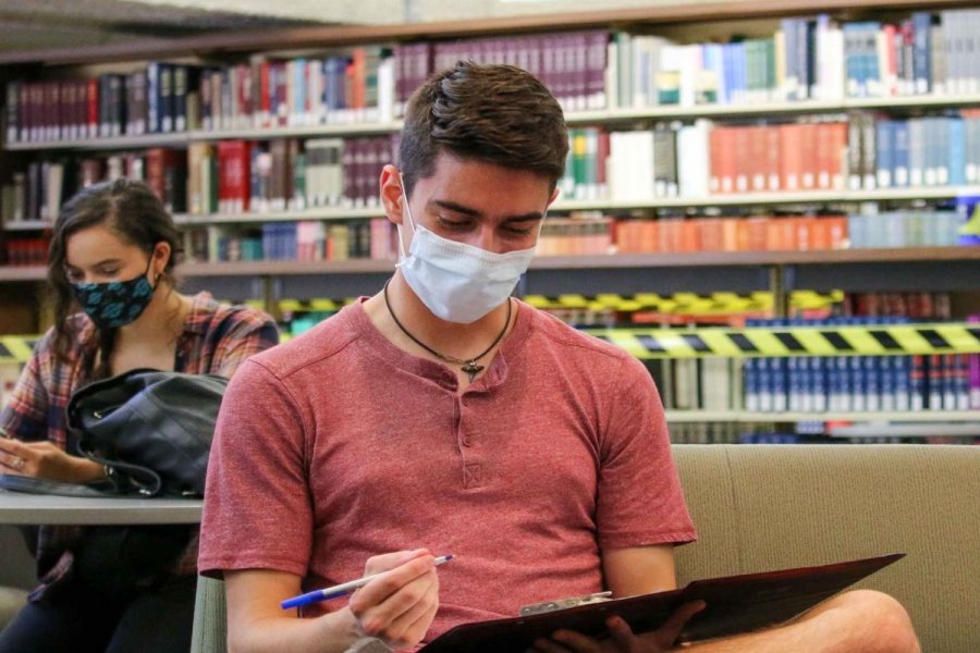 Student in mask in library at University of Manitoba