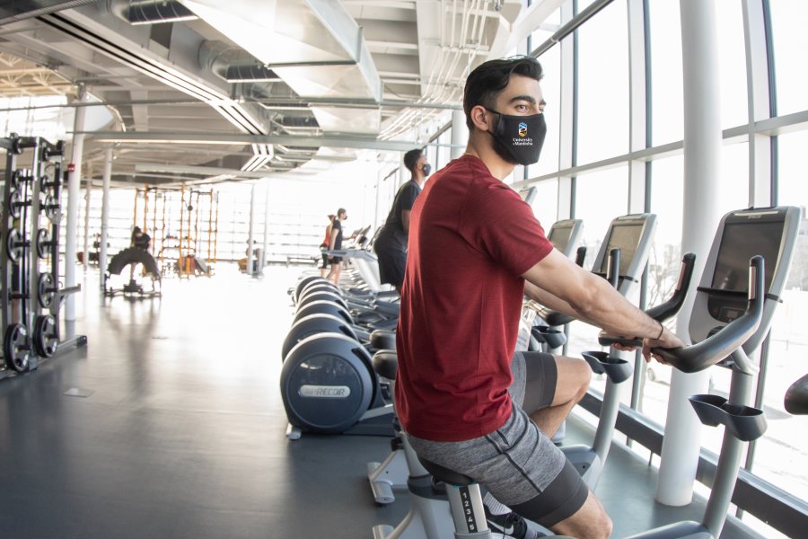 male student pictured on exercise bike in active living centre