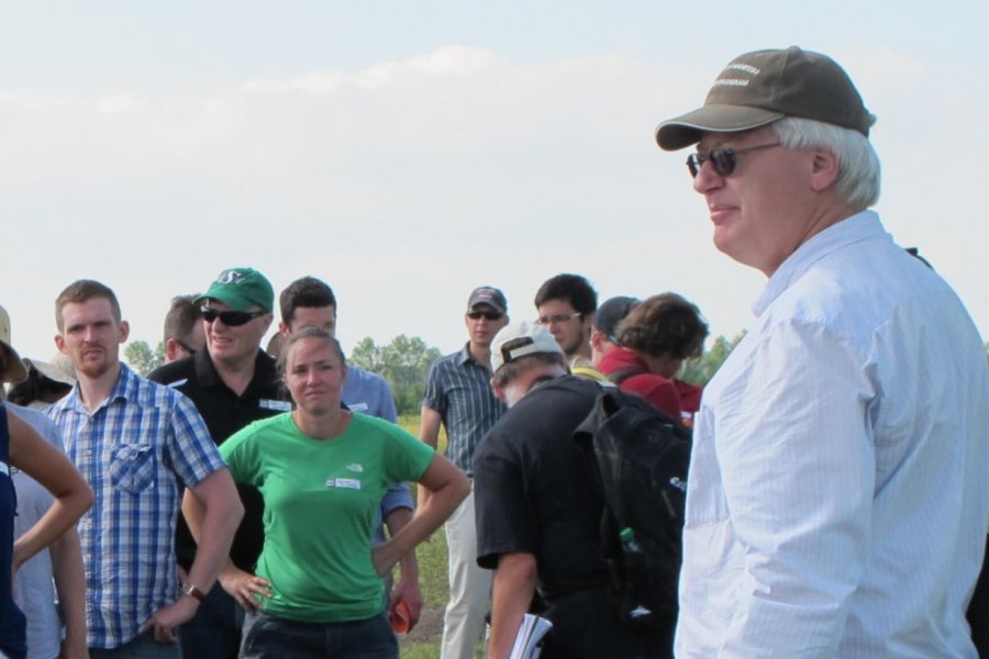 Don Flaten, Professor in the Department of Soil Science instructs students from an outdoor location.