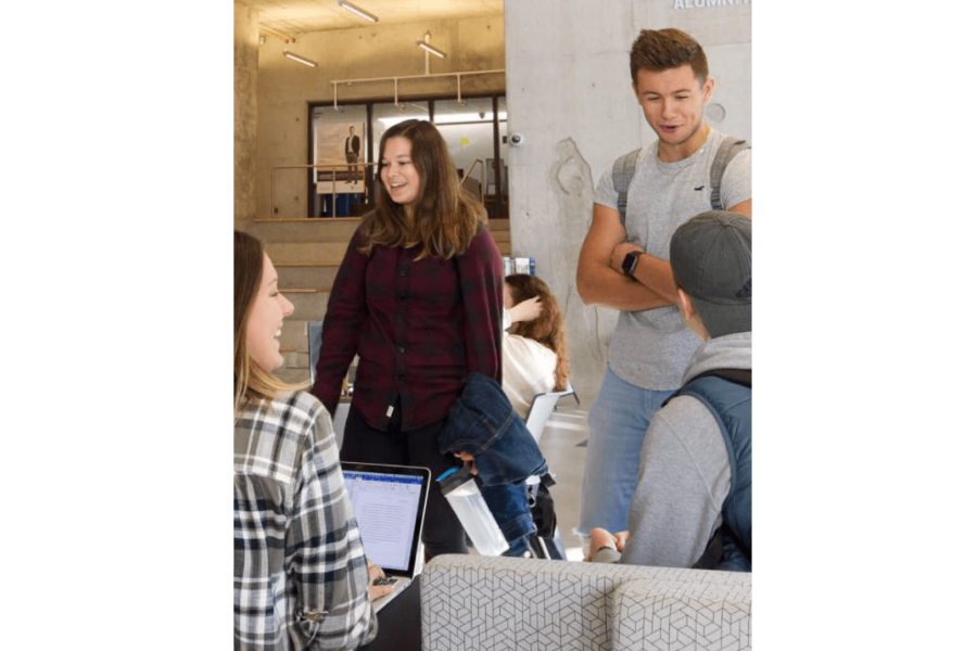 A small group of students talk to each other while studying inside the Active Living Centre.