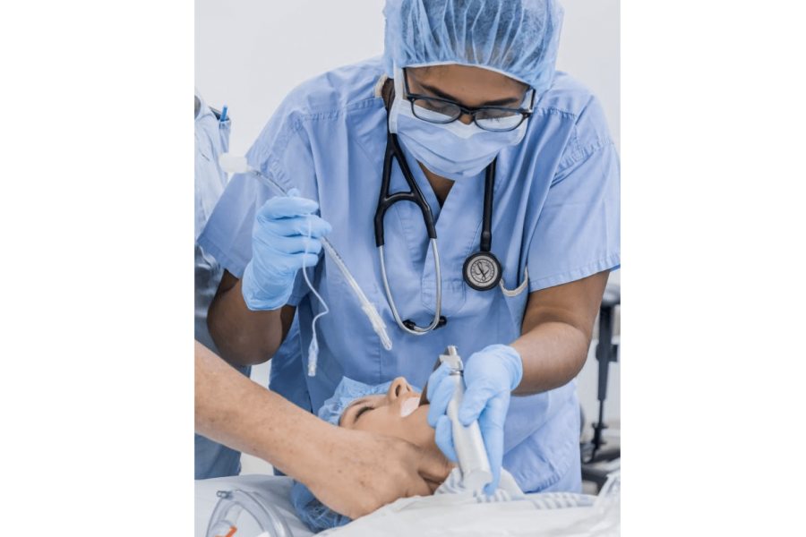 A student practices intubating a patient. 