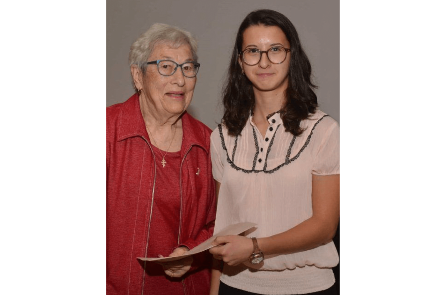 Two women standing side by side for a photo. 