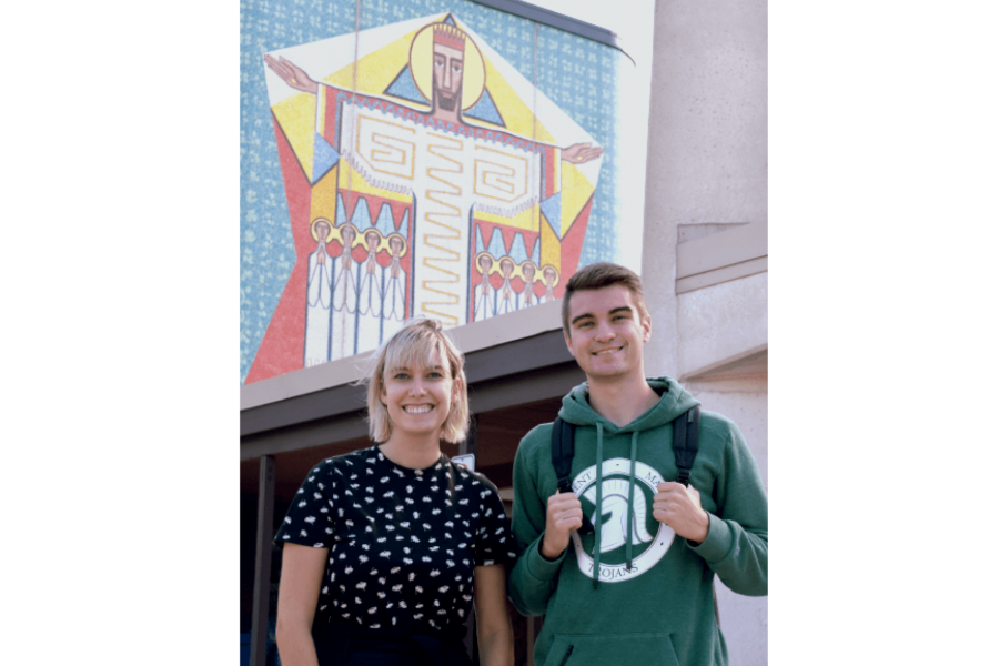 Two students stand side by side outside of St. Pauls College.