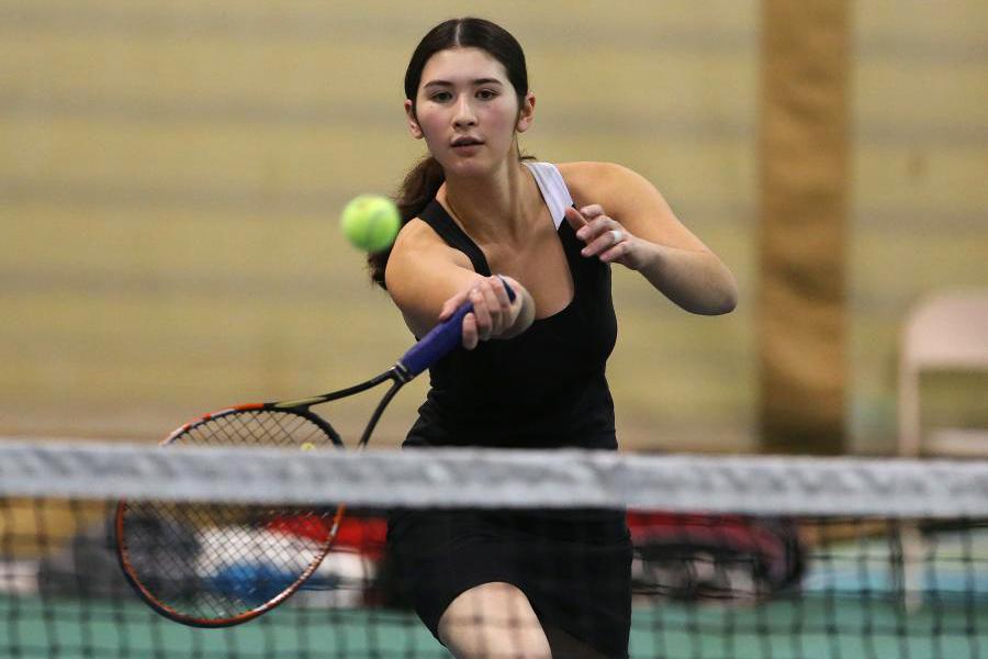 Student playing tennis