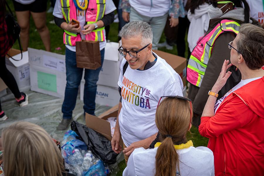 President Benarroch outdoors at pride, wearing a University of Manitoba rainbow shirt.
