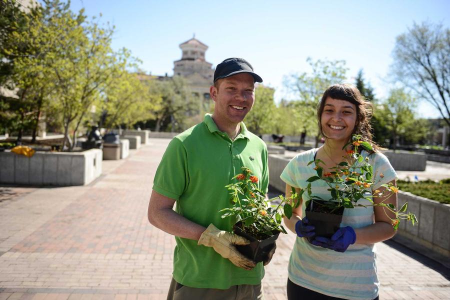 Smiling University of Manitoba staff help with gardening during Beautification Day.