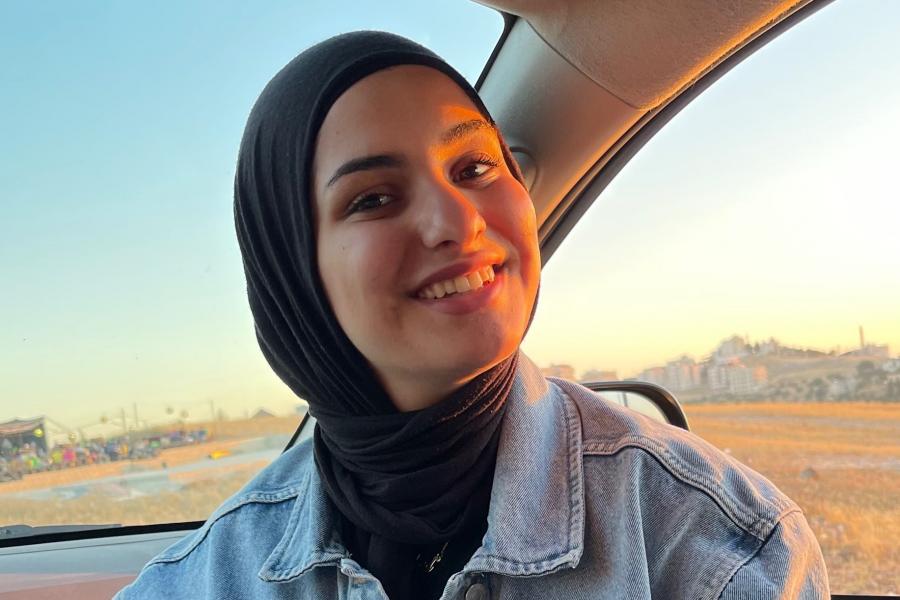 Raghad, a third-year student, smiling at the camera