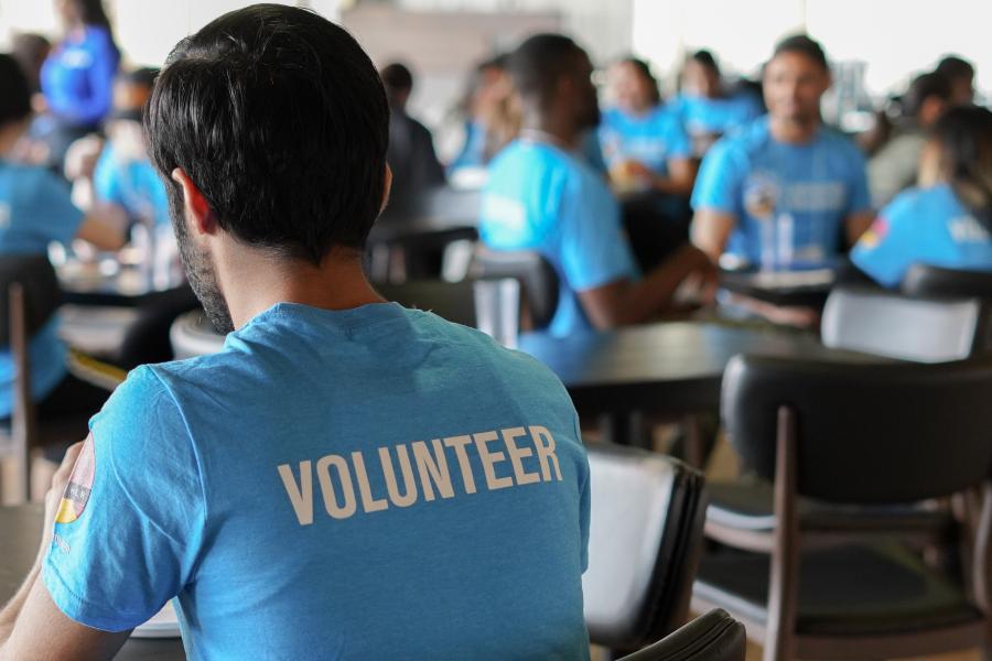 Back of a volunteer sitting at a table