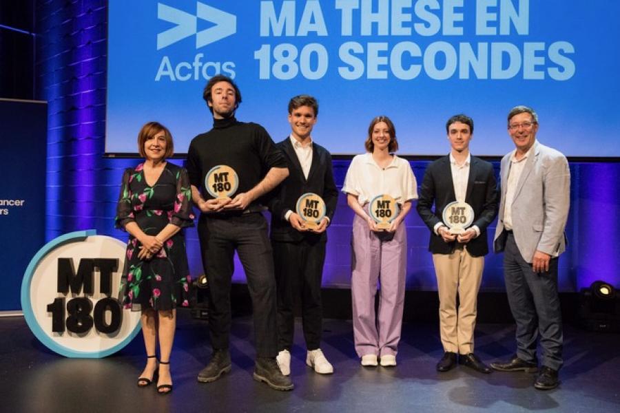 Aurélien Caron from the University of Manitoba (second from left) stands holding the MT180 3rd Jury Prize with other winners on stage.