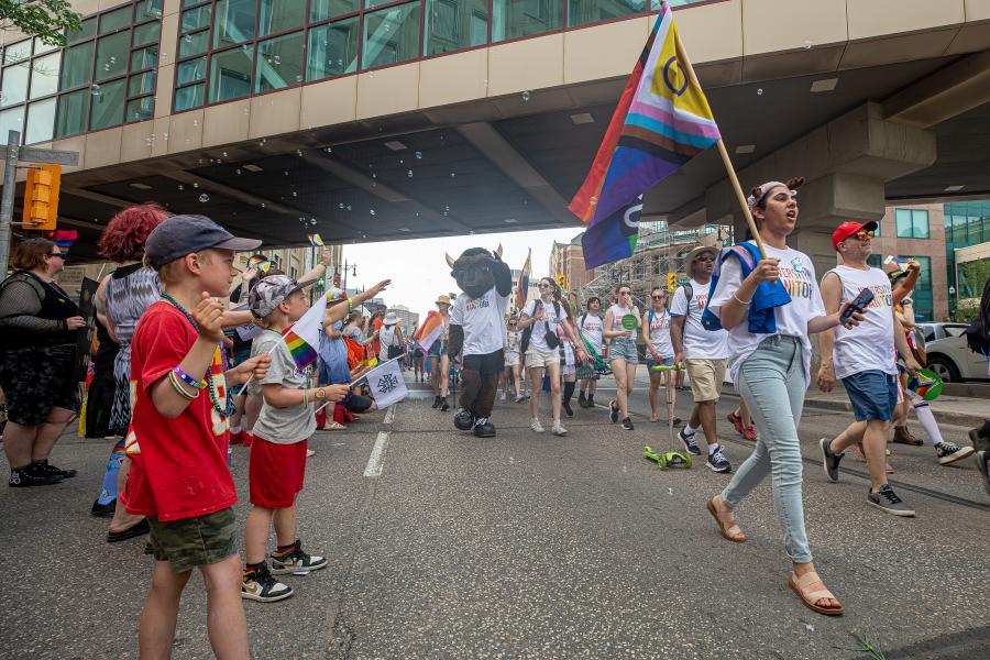 um community walks together at pride winnipeg parade