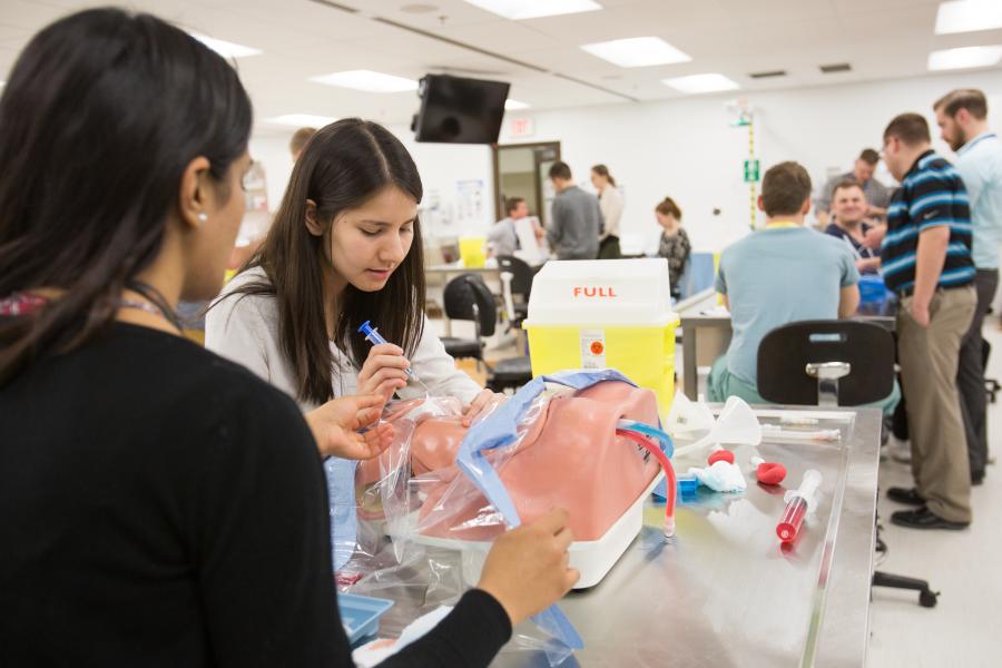 Student working in medical skills lab with Faculty 