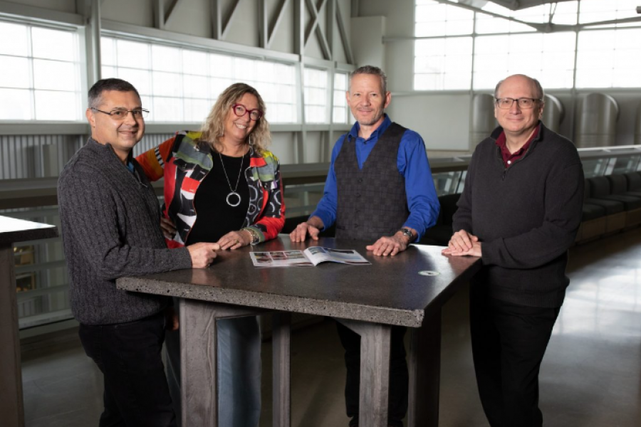 Four people standing at a table.