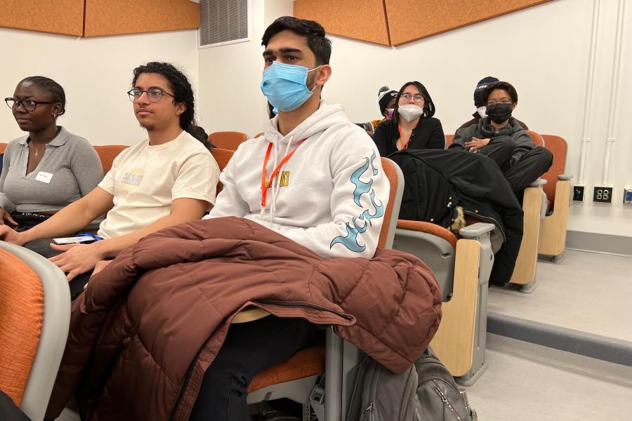 Students in the New Student Peer Mentoring Program sitting in a lecture hall during a program event