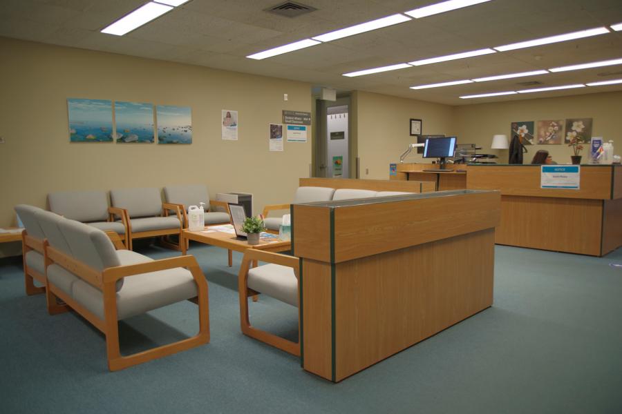 SCC Waiting area from hallway to offices with reception desk in the background