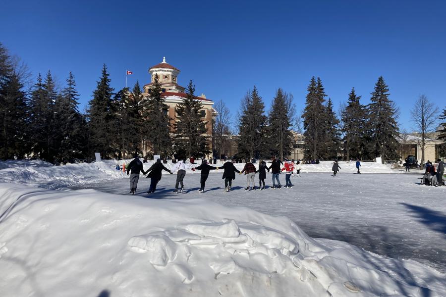 Community members holding hands while skating