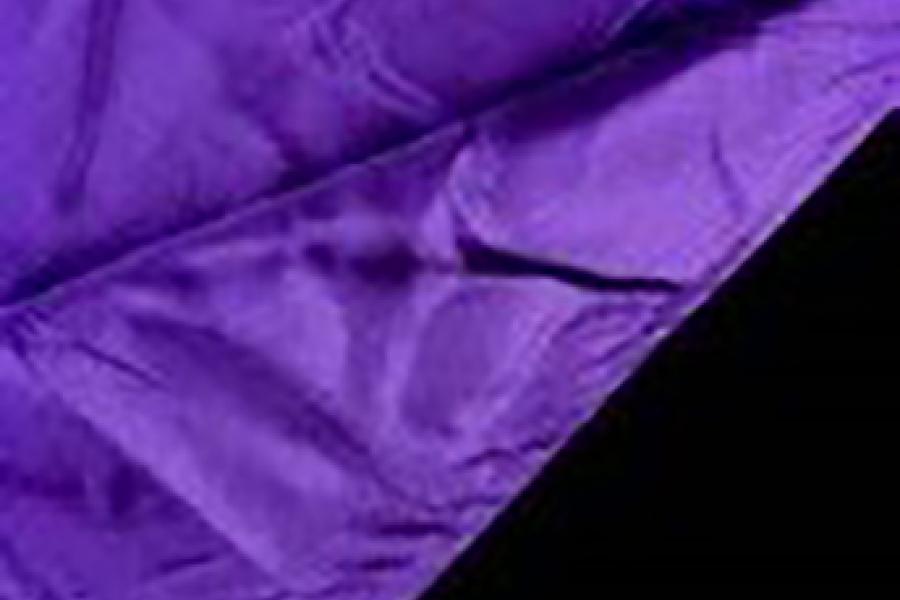 A black graduation hood with a purple lining.