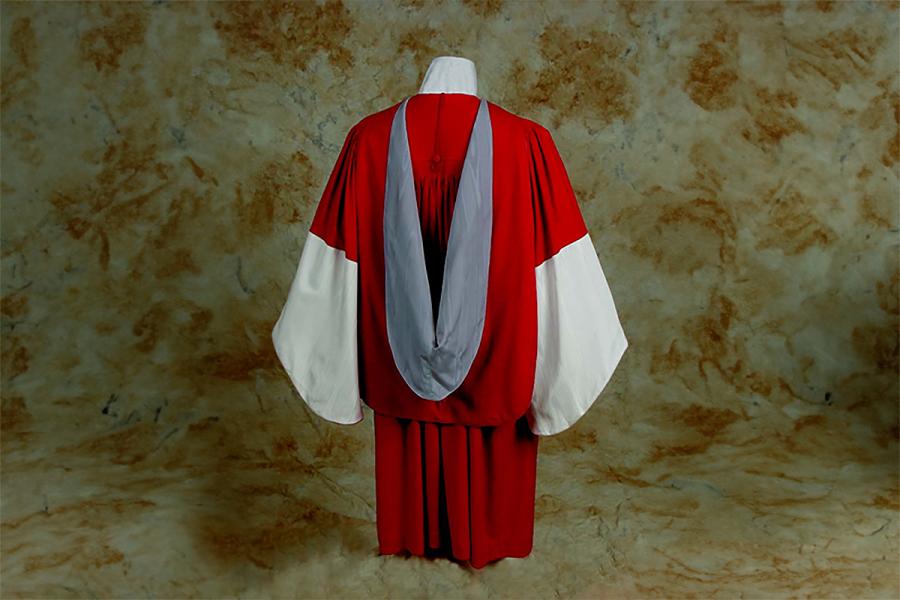 A scarlet red gown with a trim of white watered silk with a slate blue hood lining.