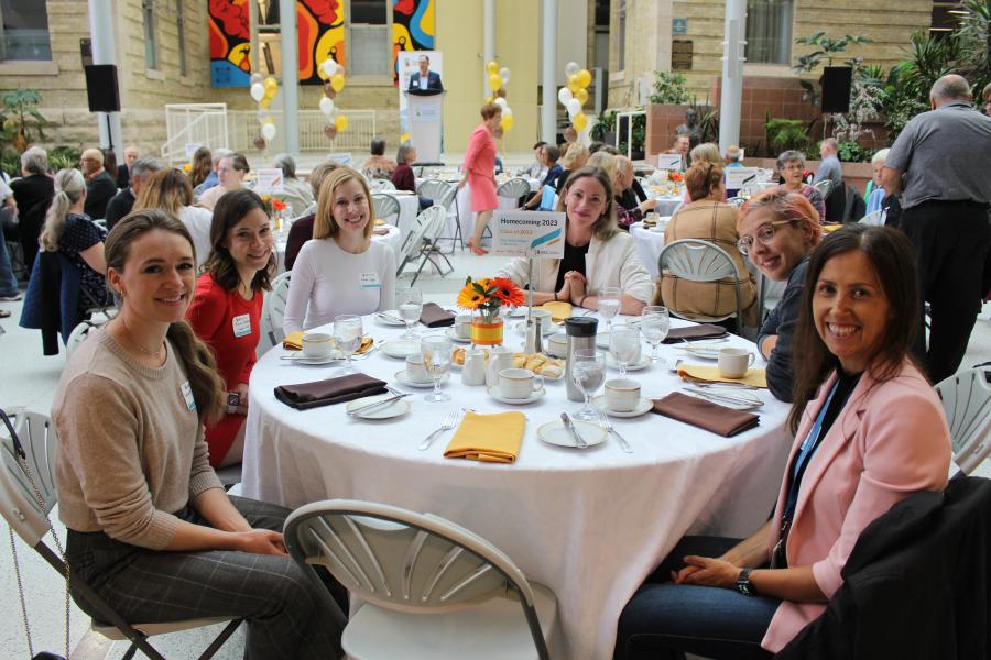 6 former classmates from the Class of 2013 seated at the Homecoming 2023 Rady Dean's Breakfast