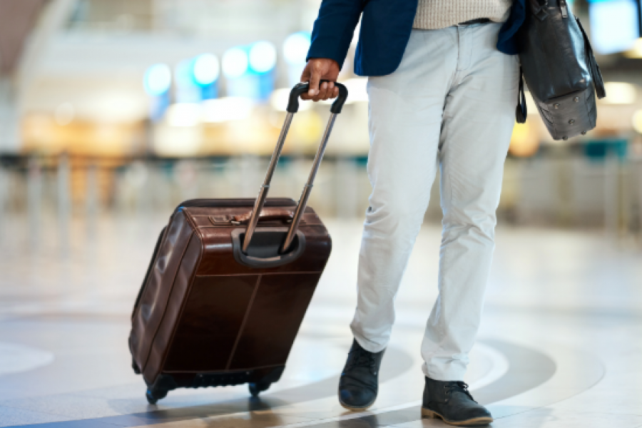 person walking with a suitcase in hand