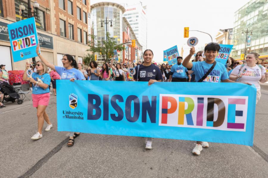 UM community members holding "Bison Pride" banner