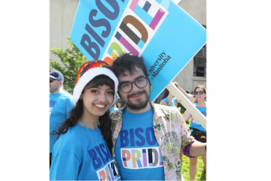 two people holding Bison Pride sign