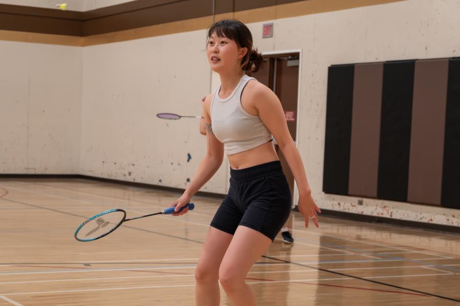 A young woman playing badminton