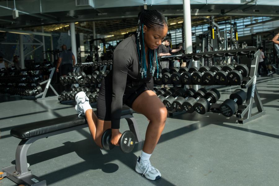 a young woman doing an exercise on a bench in the active living centre