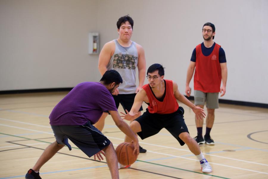 Two men playing a game of basketball