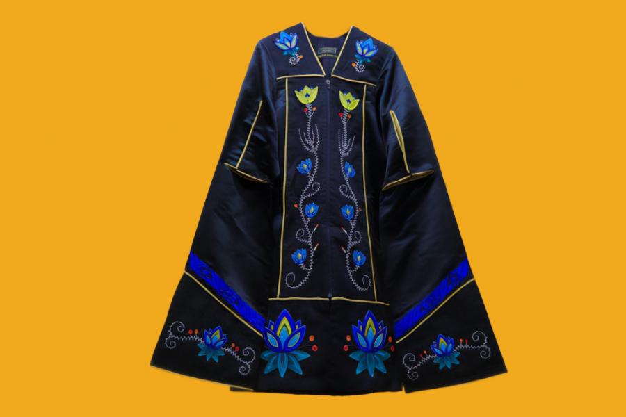 A black gown with embroidered blue and yellow flower motifs. Small red and orange motifs are also embroidered.