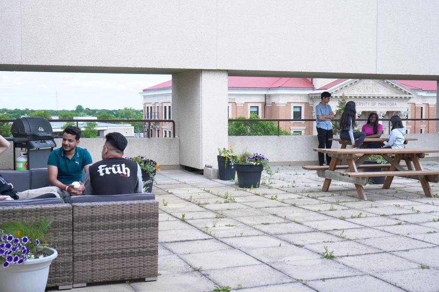 Students sitting on rooftop patio.