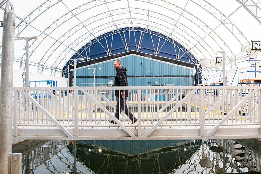 A member of the research team at the Churchill Marine Observatory walks in the facility.