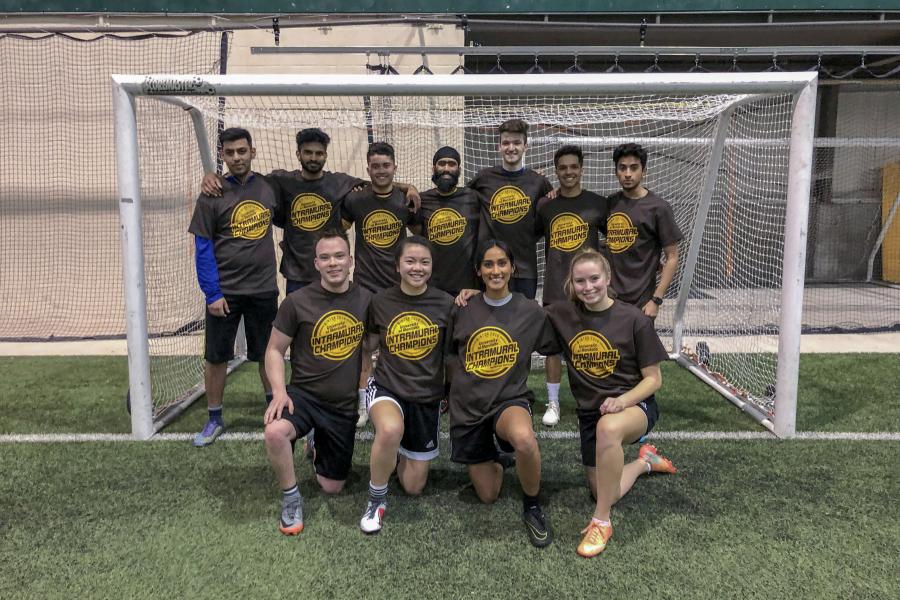 A soccer team posing together after a game