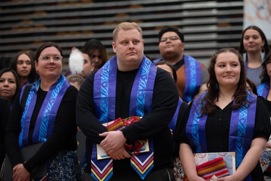 A group of graduands wearing Indigenous Graduation stoles at the Graduation Pow Wow.