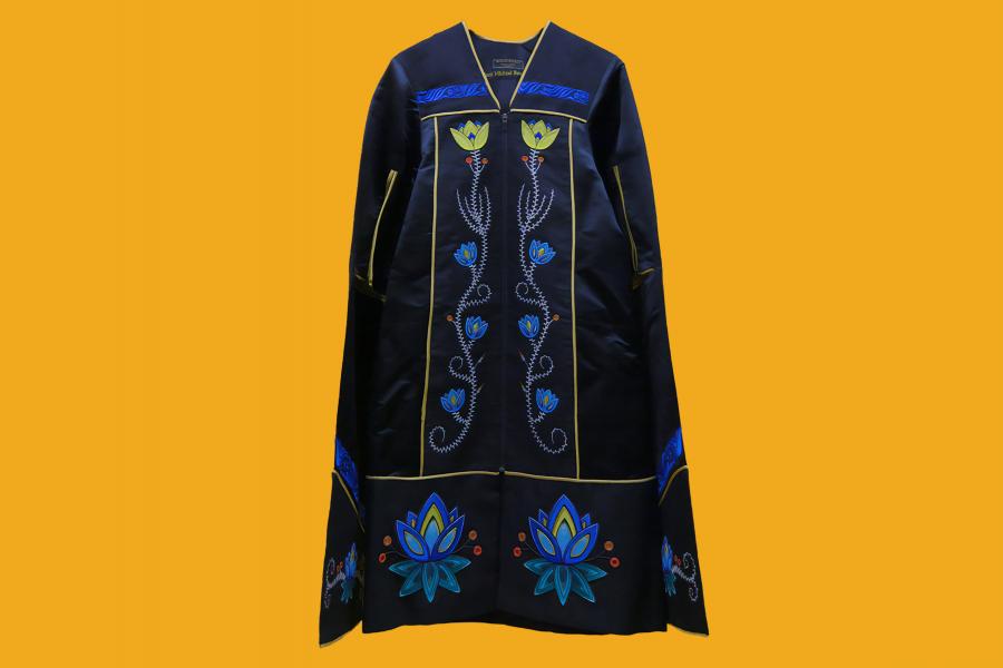 A black gown with embroidered blue and yellow flower motifs. Small red and orange motifs are also embroidered.