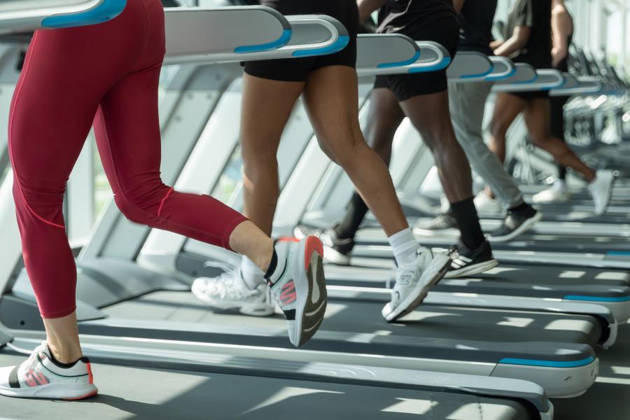 A close up on runner's feet on a treadmill