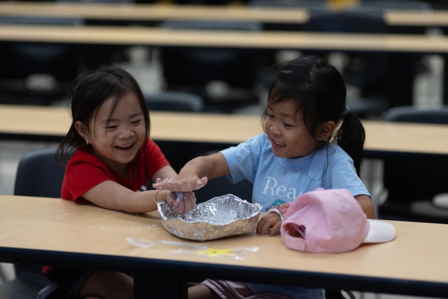 Two mini u campers doing a craft together