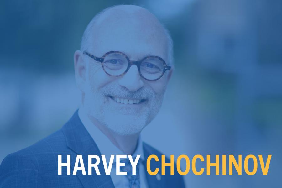 Dr. Harvey Chochinov smiling, wearing glasses and a plaid suit jacket, with stylized blue overlay on the photo. 