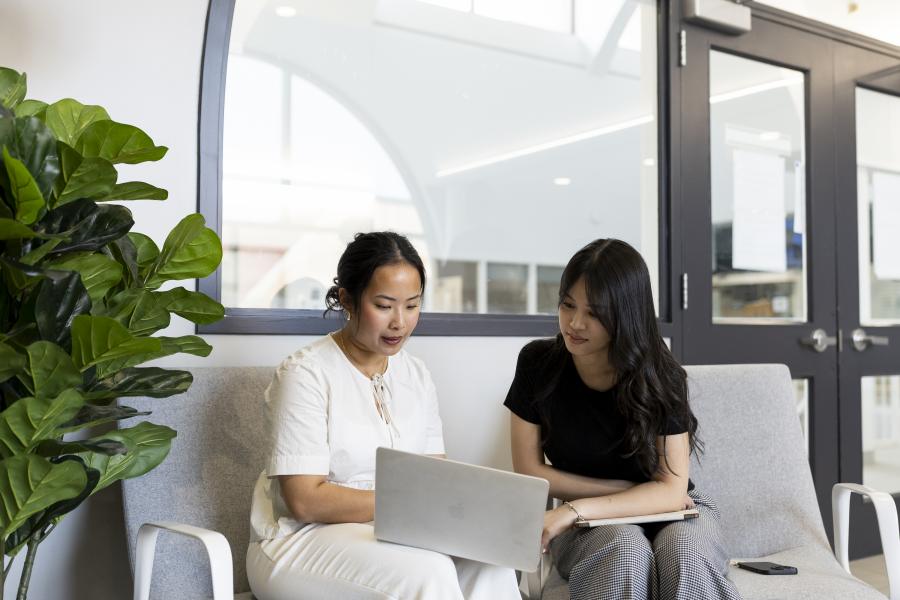 Two women looking at lap top