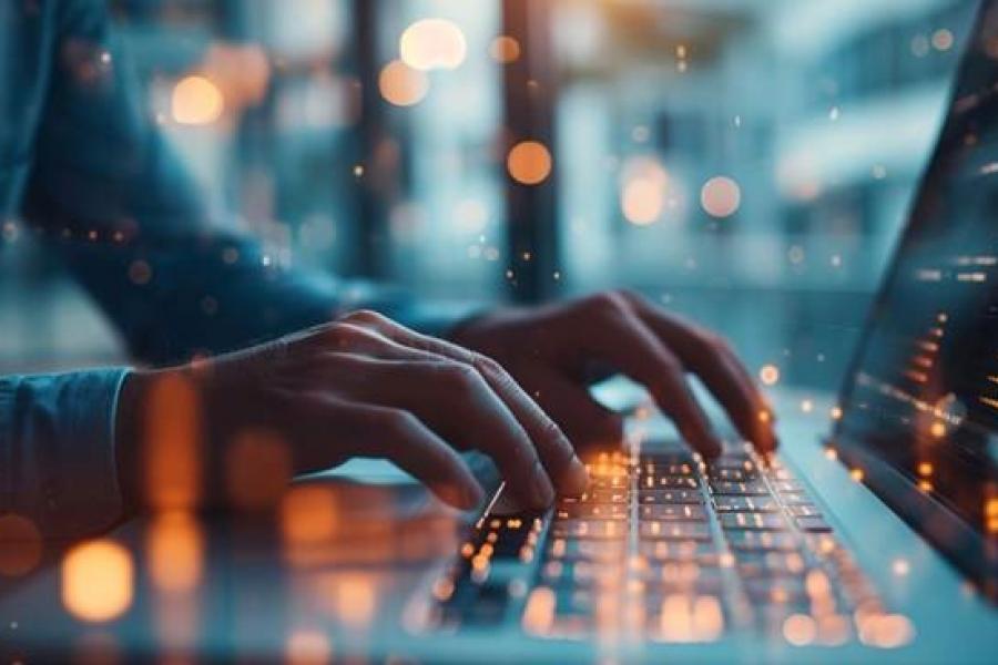 hands typing at keyboard