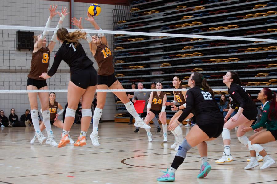 Players block the ball at Central Showdown volleyball tournament in March 2026.