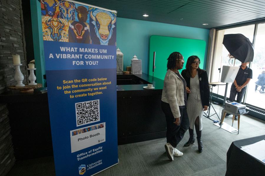 Two people standing beside a banner that says "What makes a vibrant community for you?"