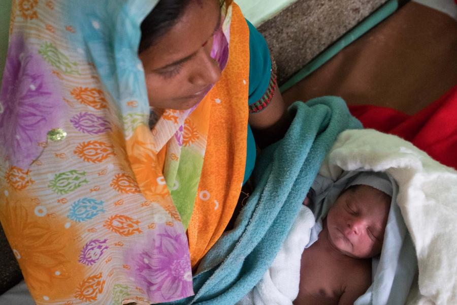 A mother holding her infant in India