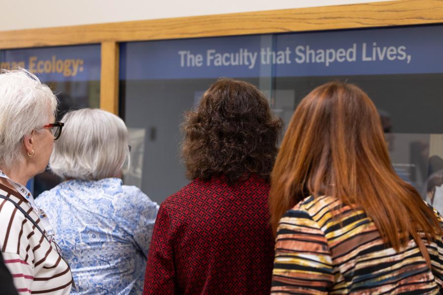Human Ecology Class of 1976 classmates gathered in front of new Human Ecology Legacy Display