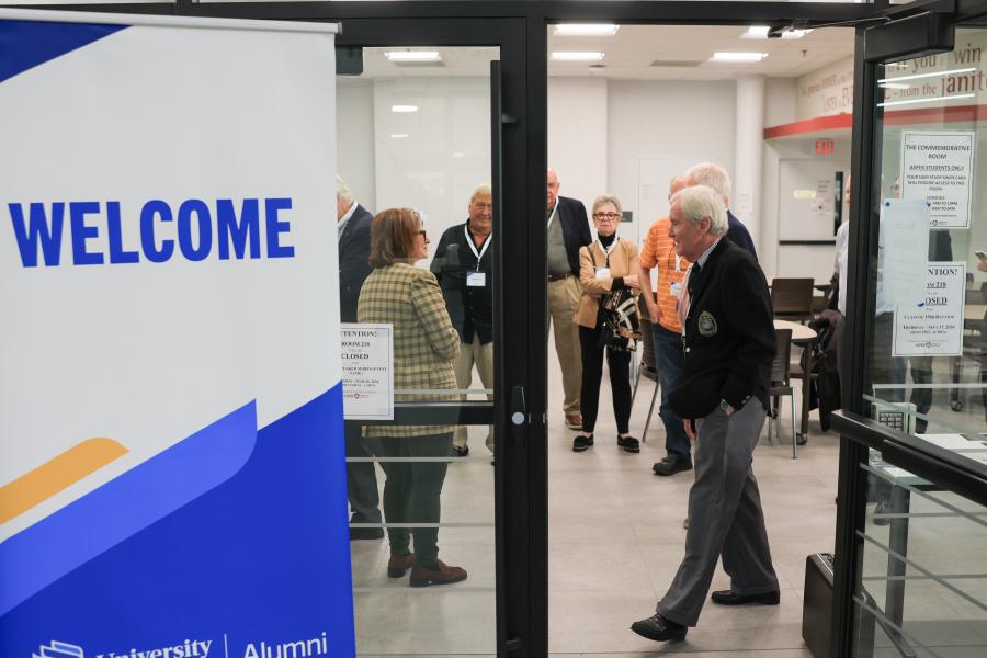 Entrance to the Commemorative Room with School of Commerce Class of 1966 reunion participants in background
